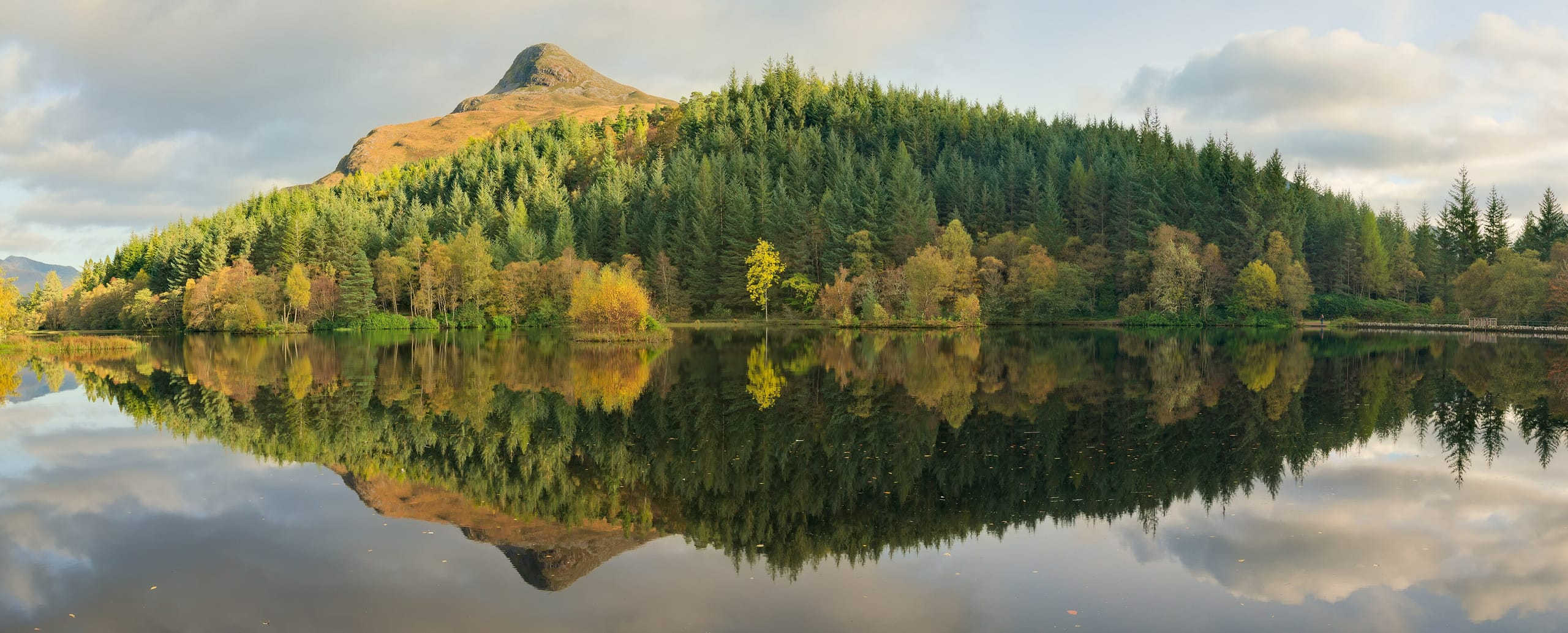 A still loch in Glencoe, the Scottish hills mirrored on the water
